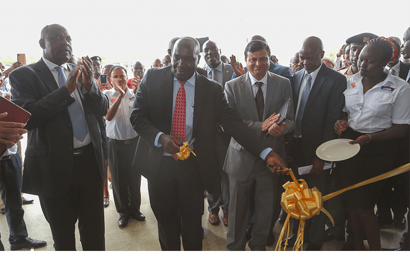 His Excellency the Governor of Kisumu, Hon Jack Raguma (left), State Department of industry and Enterprise Development - Principle Secretary, Julius Korir (centre) and Crown Paints CEO, Rakesh Rao cut a ribbon to officially open the new Crown Paints Factory in Kisumu City.