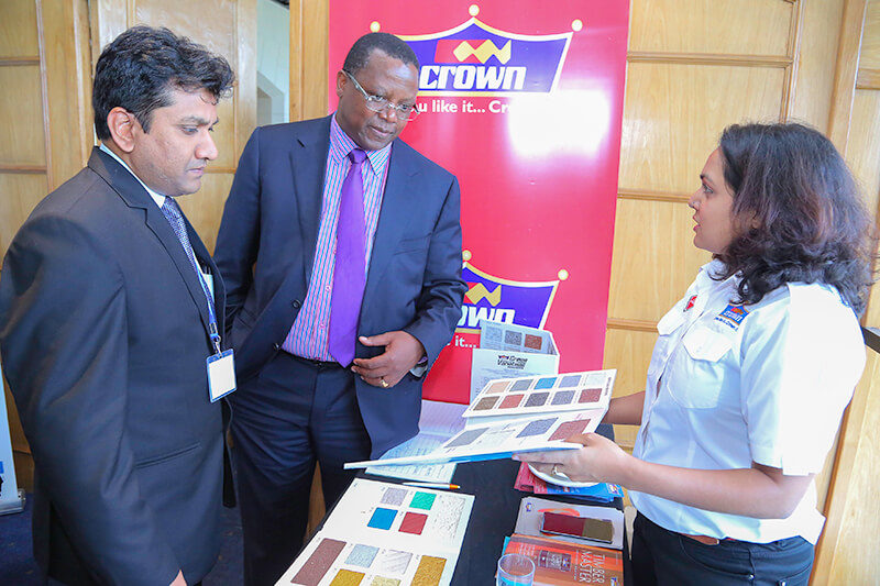 Crown Paints, Head of Sales, Rakesh Ranjan (left) and Crown Paints Marketing Officer, Roshni Vora (right) take Suraya Property Group Limited- CEO, Peter Muraya through a colour chart.