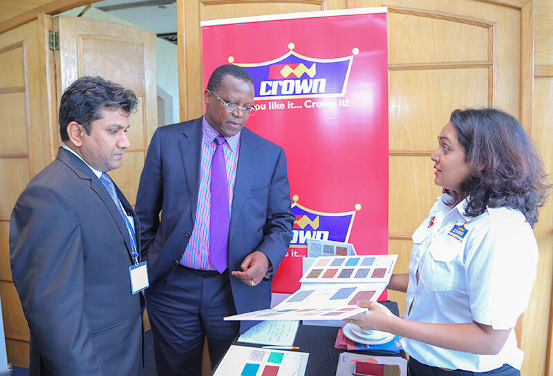 Crown Paints, Head of Sales, Rakesh Ranjan (left) and Crown Paints Marketing Officer, Roshni Vora (right) take Suraya Property Group Limited- CEO, Peter Muraya through a colour chart.